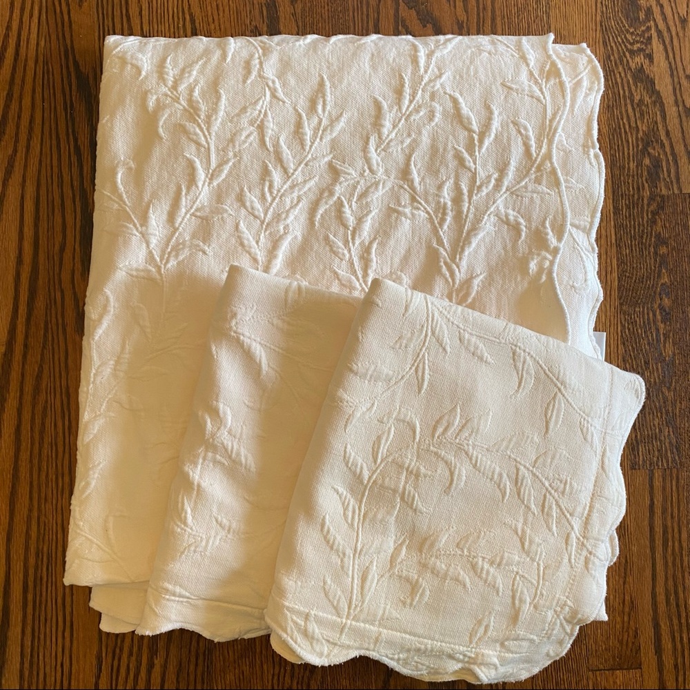 Cream colored queen quilt and matching Euro shams.